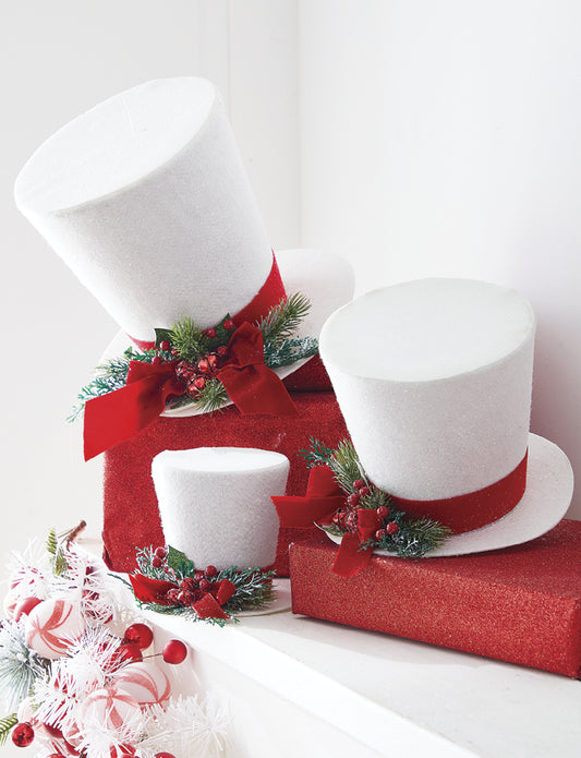 White Top Hat Ornaments. Snowy white. Green pine, holly, and red jingle bell detail. Made of Polyester, Paper and Foam.