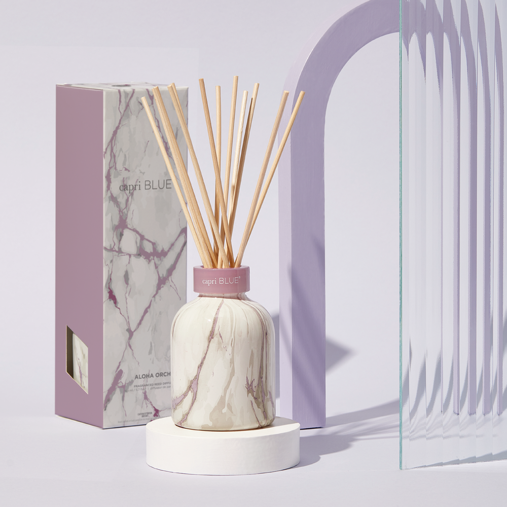 Capri Blue's Aloha Orchid Modern Marble Petite Reed Diffuser, 5.7 fl oz. Amethyst design topped with etched glass collar.