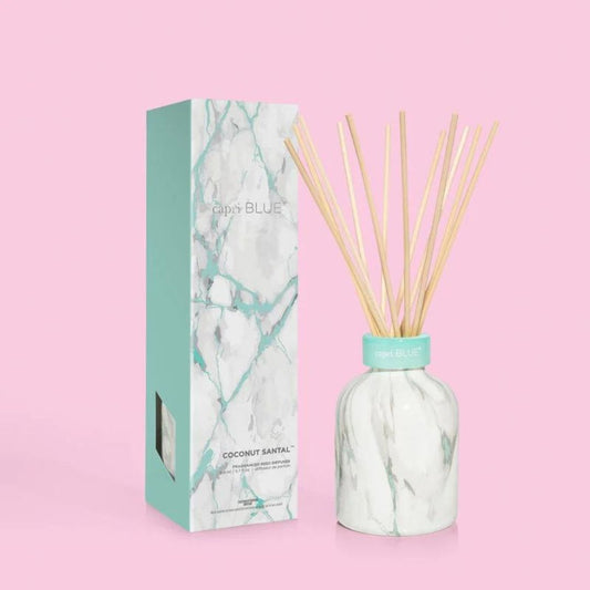 Capri Blue's Coconut Santal Modern Marble Petite Reed Diffuser, 5.7 fl oz. Sky-blue design topped with etched glass collar.
