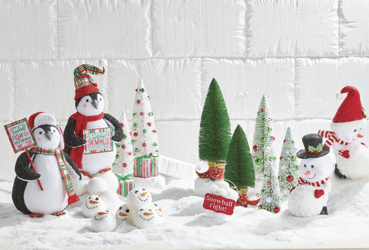 20.25" North Pole Friends Penguins and snowmen surrounding mini Christmas trees and ornaments on faux snow.